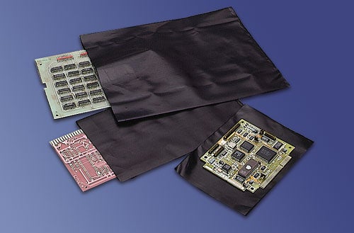 three black conductive bags holding microchips on blue background