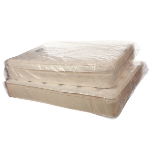 two white mattresses in mattress bags stacked on top of each other