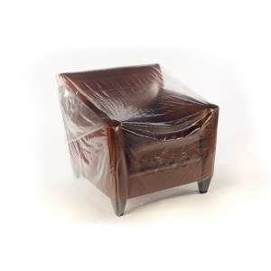 brown leather chair in clear plastic furniture cover