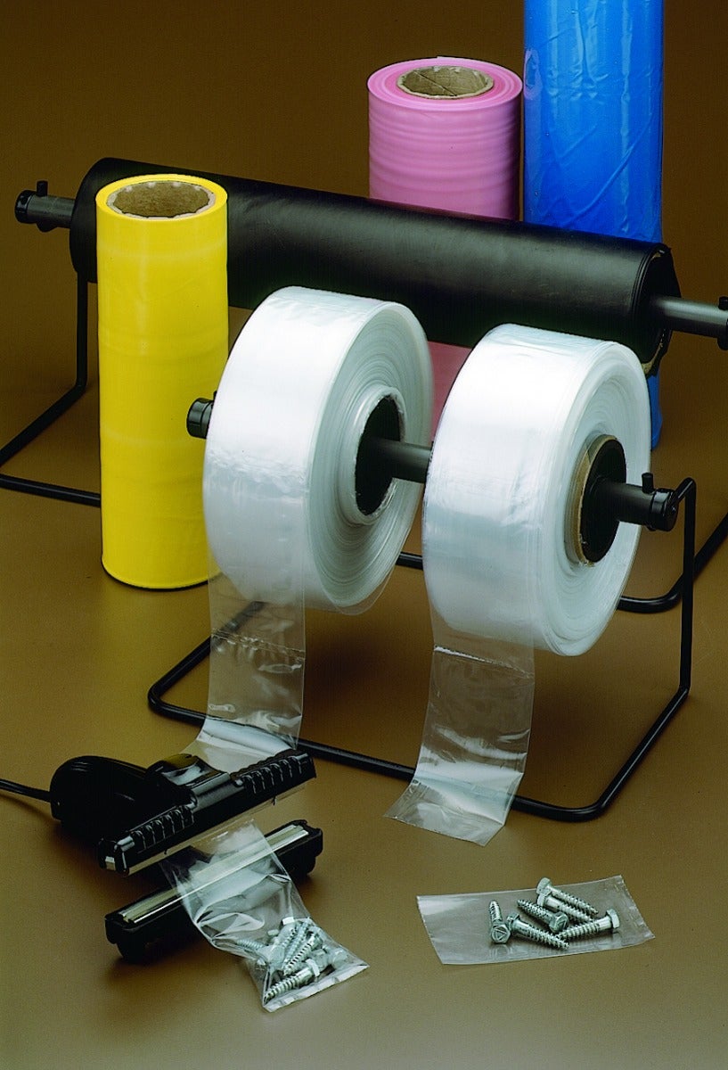 two rolls of clear poly tubing on dispenser behind heat sealer