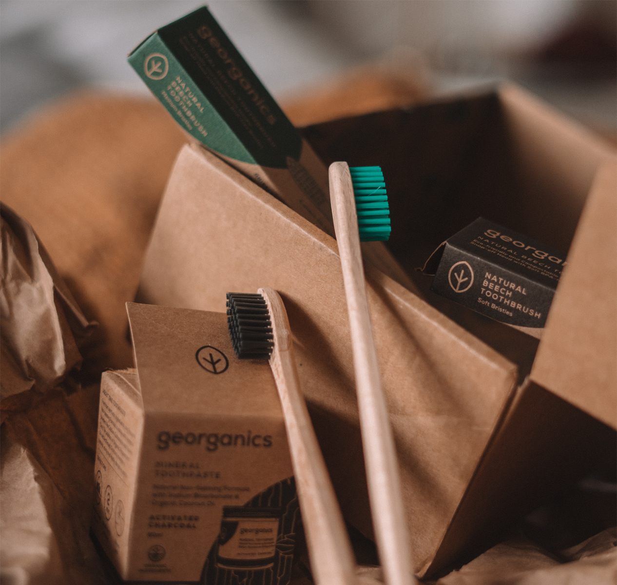 wooden toothbrushes packaged in small recyclable corrugated boxes